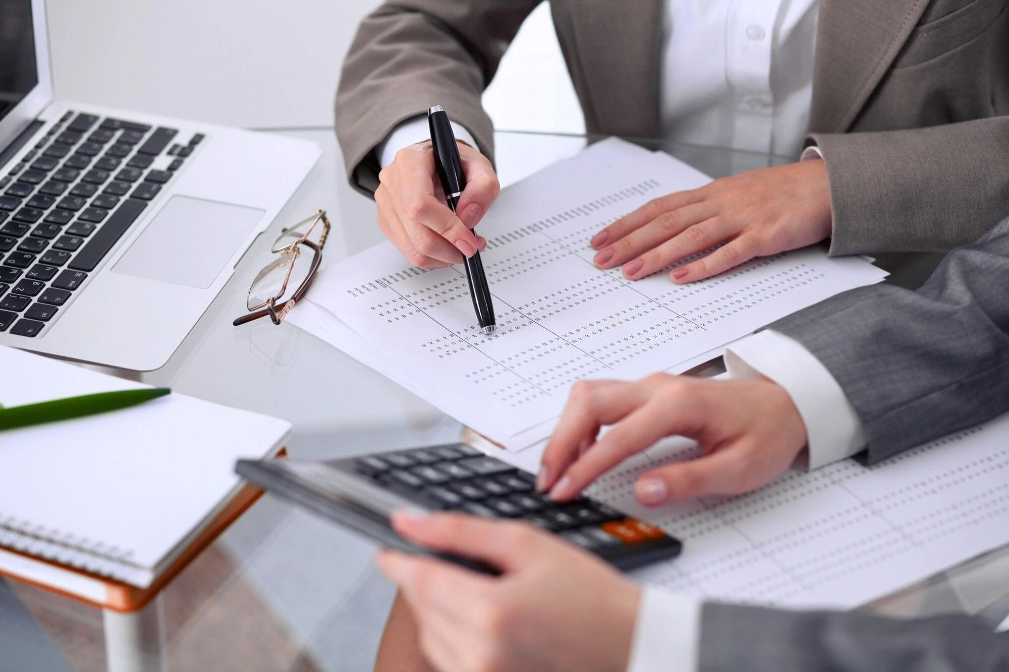 A person holding a calculator. A person holding a calculator.